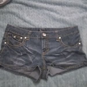 Left pocket ripped open, short jean shorts, 15